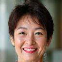 Portrait of Sarah Chen, a smiling woman in her late 40s, looking healthy and vibrant, with a soft, natural background.